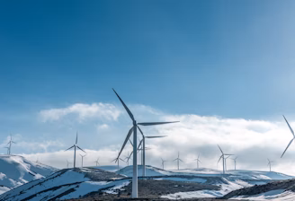 wind turbines on snowy mountain under clear blue sky during daytime